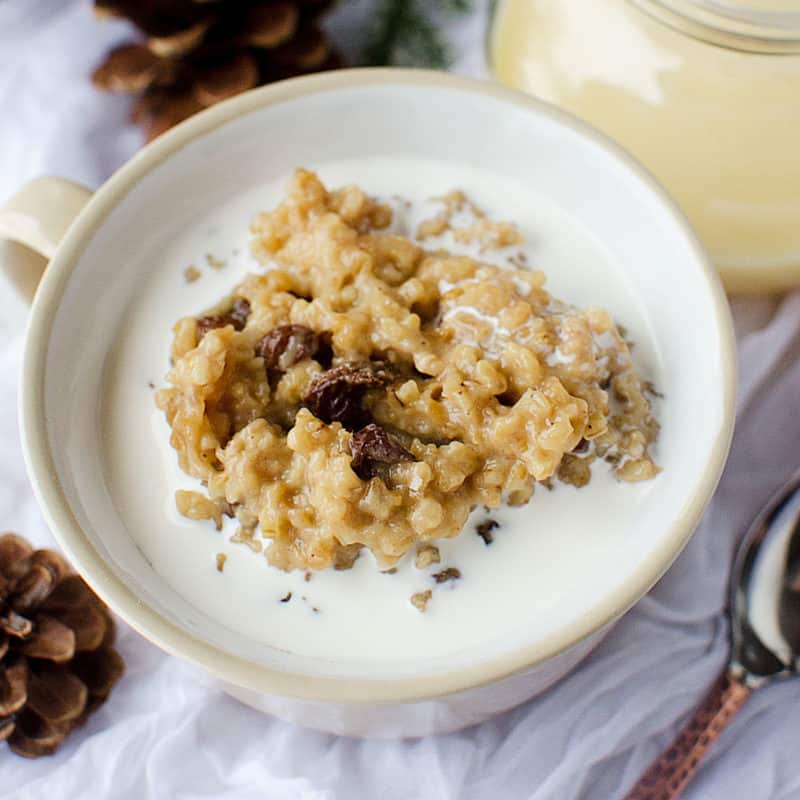 Crock Pot Eggnog Oatmeal in a white bowl next to a spoon