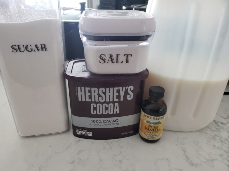 Sugar, Salt, Hershey's Cocoa, vanilla, and milk on a counter