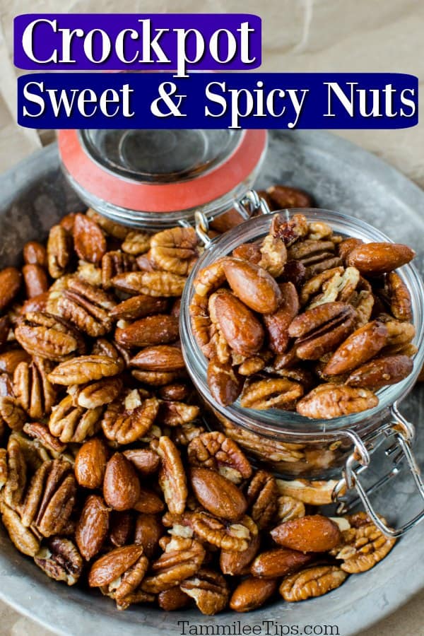 crockpot sweet and spicy nuts on a silver plate with a glass dish in the middle filled with nuts
