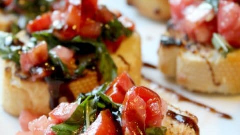 Super Easy Bruschetta text over a platter of tomato bruschetta