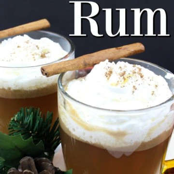 Hot Buttered Rum in a glass mug with a cinnamon stick
