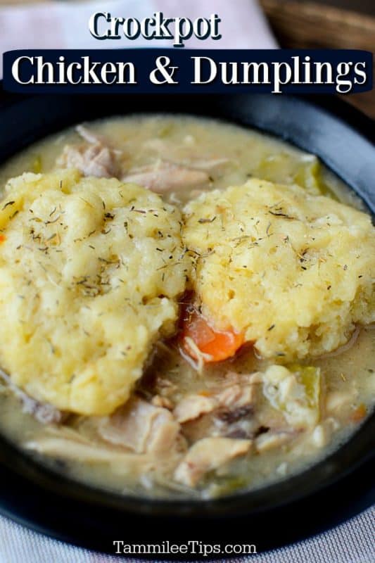 Crockpot chicken and dumplings over a dark bowl with dumplings on top of chicken