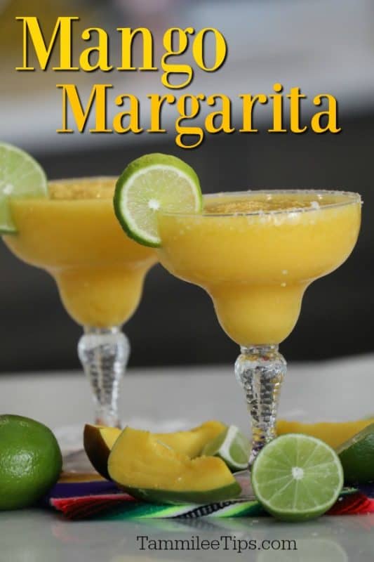 Mango Margarita over two margarita glasses with lime wheels, mangos and lime wedges