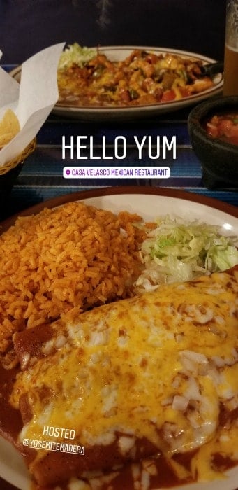 Cheese enchiladas with rice on a white plate with a 2nd plate in the background at Casa Valascos Restaurant, Bass Lake