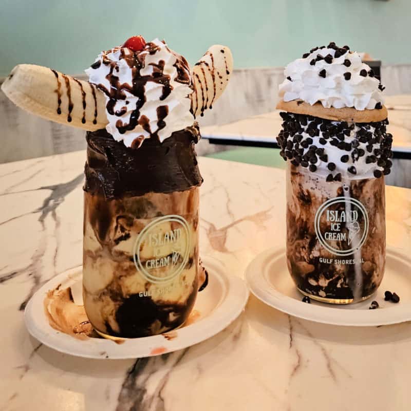 two large milkshakes in mason jars with whipped cream, and so much more