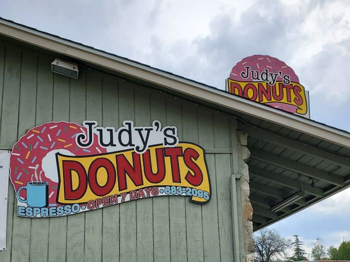 Judy's Donuts sign on the side of a green building