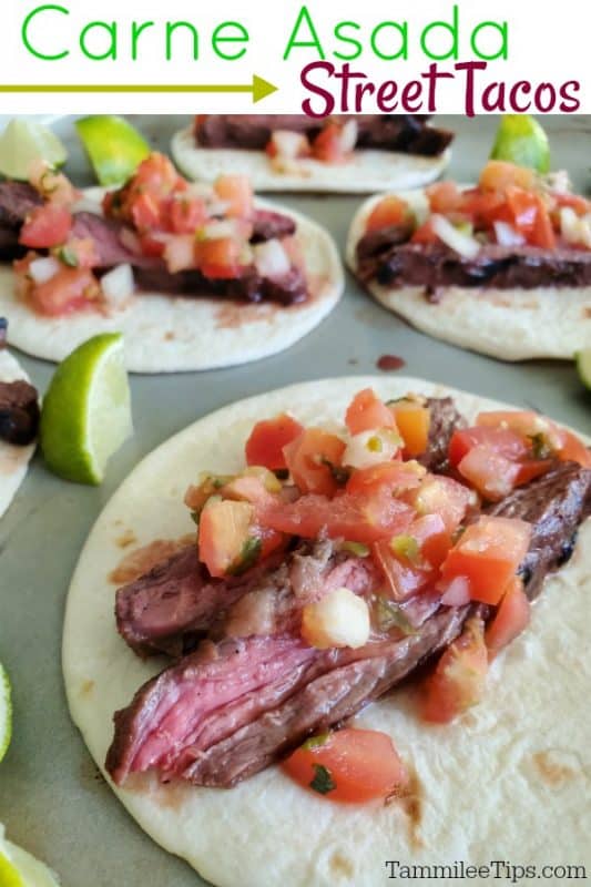 Carne Asada Street Tacos over a baking sheet with tacos and lime wedges. 