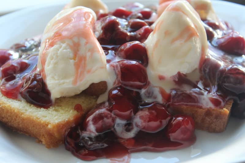 Cherries jubilee on pound cake with 2 scoops of ice cream