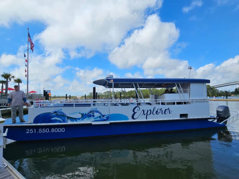 Explorer Dolphin Cruise Boat on the water with clouds in the sky