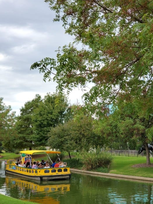 Yellow water taxi next to trees