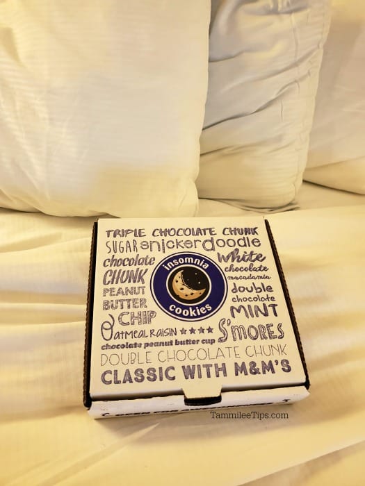 Insomnia cookies box on white comforter. 
