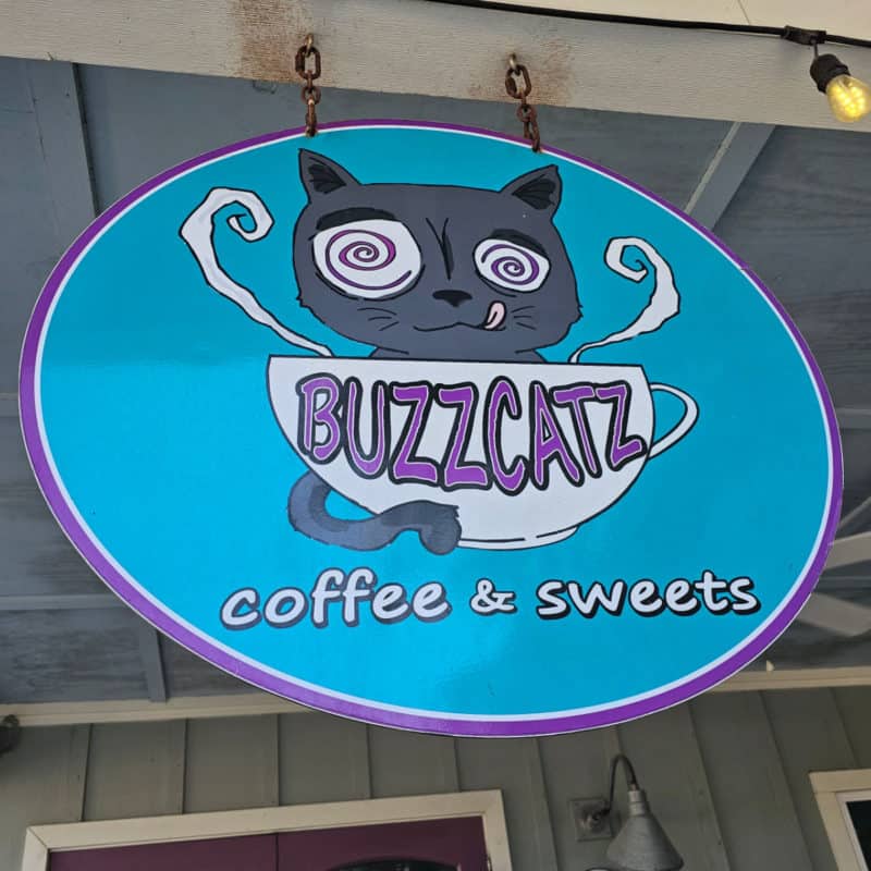 BuzzCatz entrance sign with a cat and coffee mug