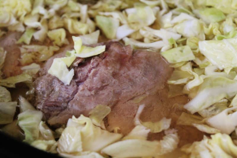 corned beef in the slow cooker with cabbage floating 
