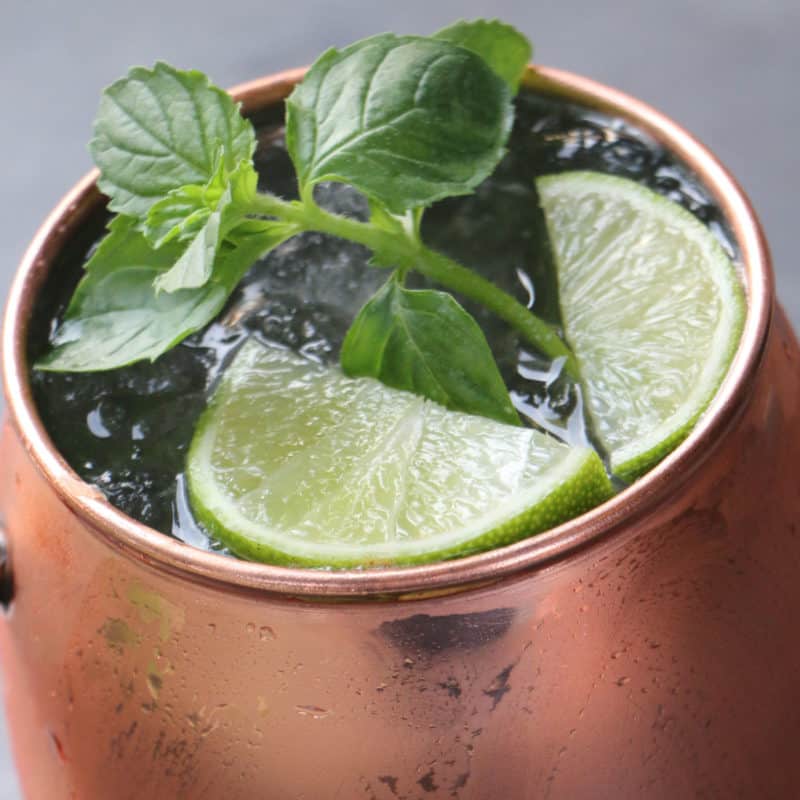 Classic Moscow Mule in a copper mug with mint leaves and lime wedges