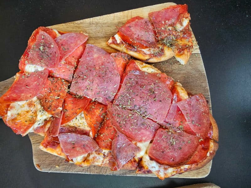 Pepperoni flatbread pizza on a wood board