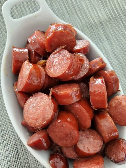 Brown sugar kielbasa bites in a white serving bowl