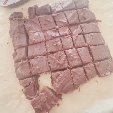 2 Ingredient Nutella Fudge cut into squares on parchment paper