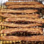 strips of brown sugar bacon candy on a wire rack