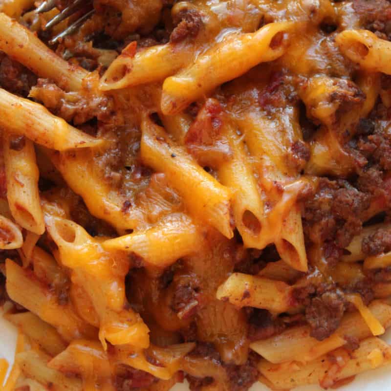 cheesy pasta and beef casserole on a white plate