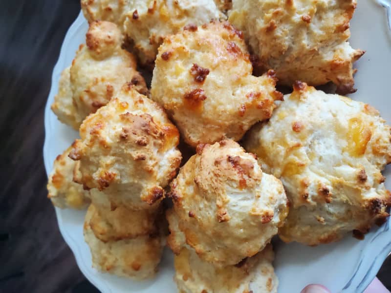 Cheddar Biscuits piled on a white plate