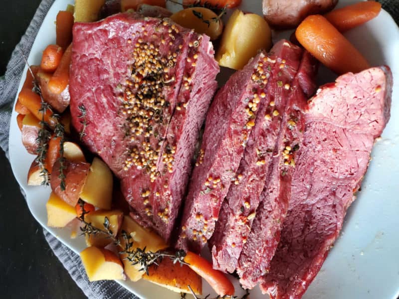 Guinness Corned Beef sliced with carrots, potatoes and herbs