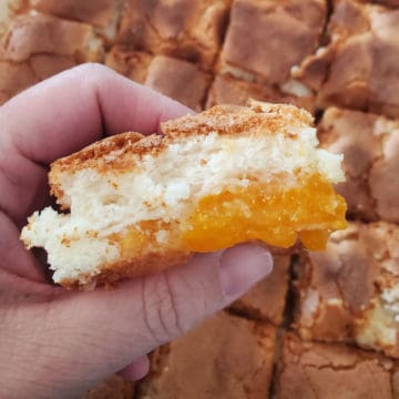 Mandarin Orange Angel Food Cake slice being held in a hand