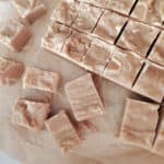 Squares of 4 Ingredient Peanut Butter Fudge on parchment paper