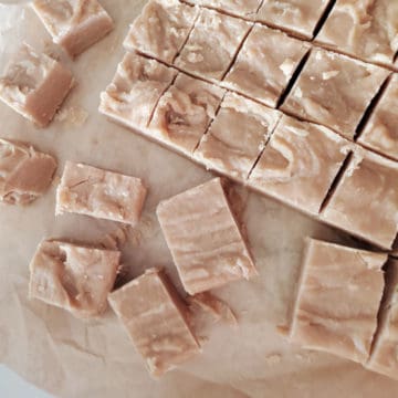 Squares of 4 Ingredient Peanut Butter Fudge on parchment paper