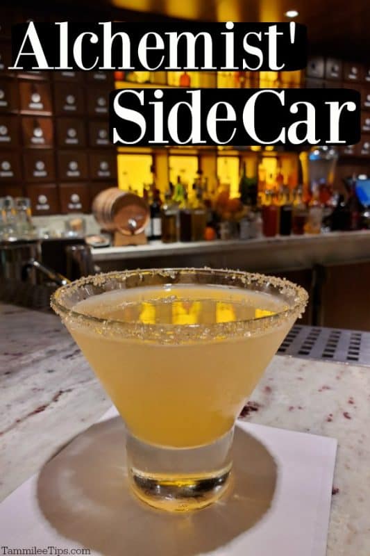 Alchemist' Sidecar text over a stemless martini glass with sugared rim