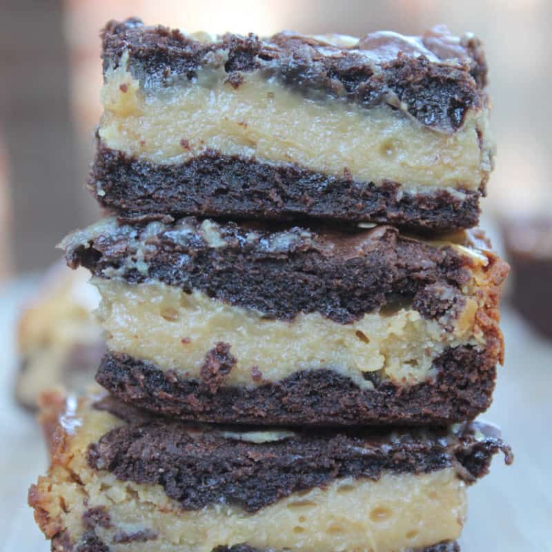 Stack of peanut butter chocolate buckeye bars on a wood plate