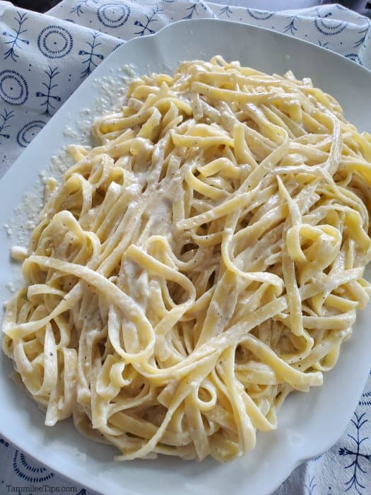 Olive garden homemade alfredo sauce with fettuccine noodles on a white platter