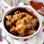 Apple cinnamon oatmeal in a bowl on a cloth napkin