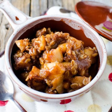 Apple cinnamon oatmeal in a bowl on a cloth napkin