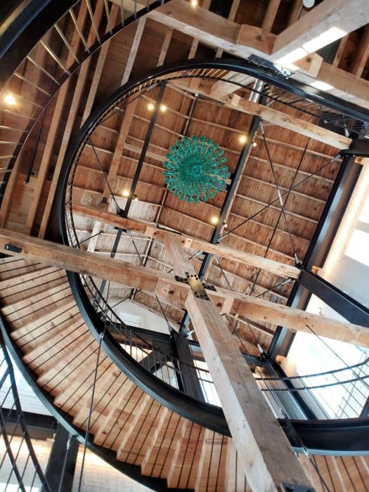 Looking up at stairs and the green chandelier in Bentley Heritage Distillery in Minden Nevada 