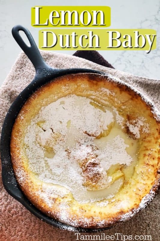 Lemon Dutch Baby text over a cast iron skillet with lemon Dutch baby covered in powdered sugar sitting on a towel 