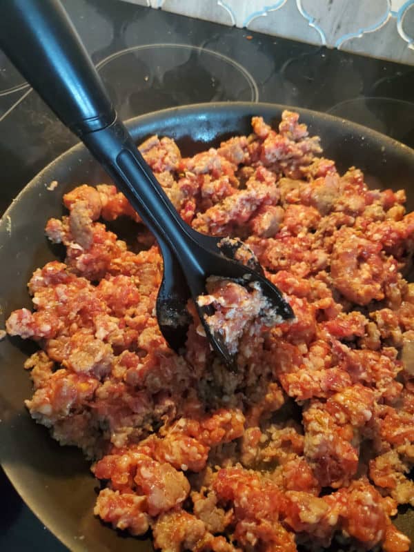 Mix in chop breaking up ground sausage in a dark skillet