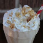 Sonic Coconut Cream Pie Shake in a shake glass garnished with whipped cream and graham cracker crumbs
