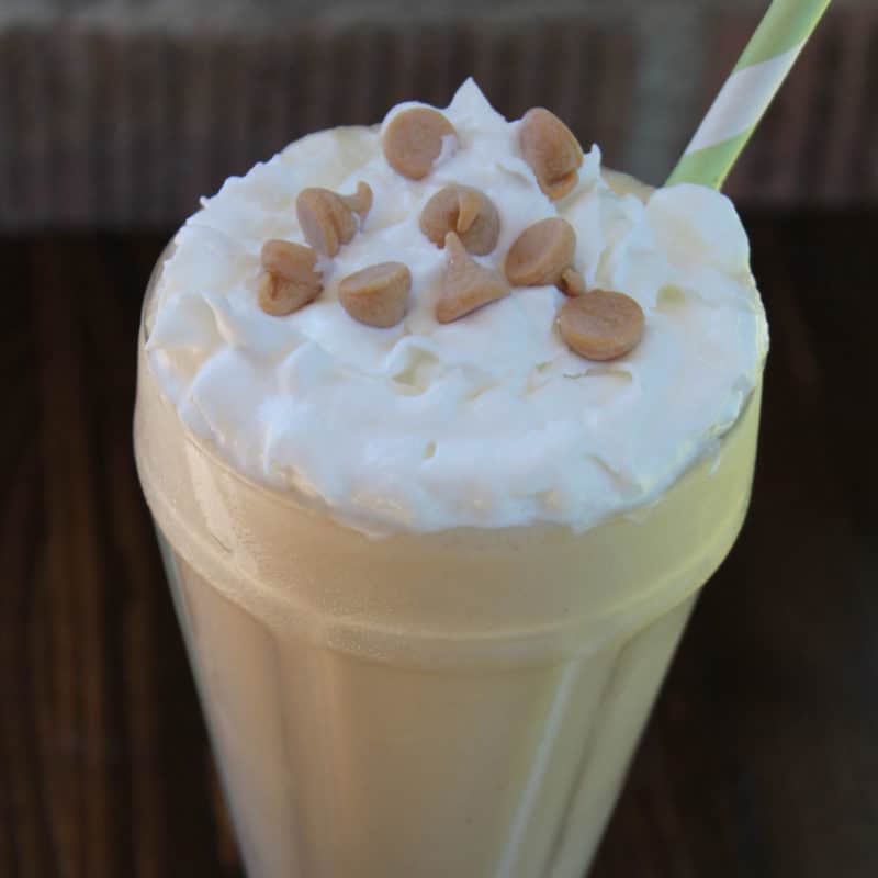 Sonic Peanut Butter Shake in a tall glass with whipped cream and peanut butter chips