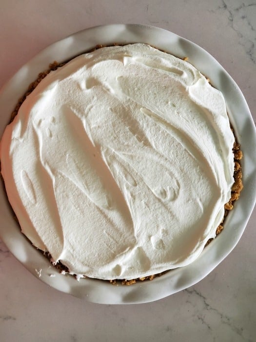 Whipped topping on a pie in a pie dish