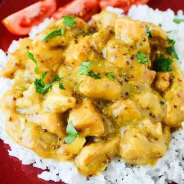 Honey Mustard chicken on a bed of white rice near tomato slices