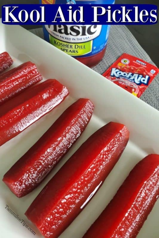 cherry kool aid pickles on a white platter with a jar of pickles and cherry kool aid packet