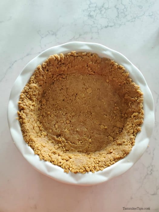 Nutter butter crust in a white pie dish. 