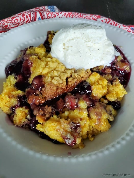 Lemon Blueberry Dump Cake in a white bowl with vanilla ice cream