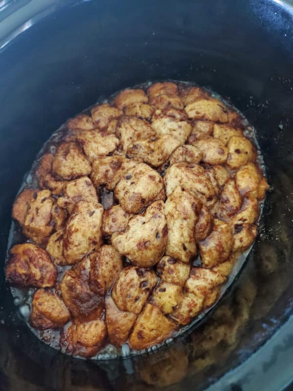 monkey bread in a black slow cooker bowl after cooking
