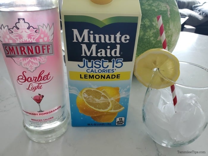 Smirnoff sorbet light bottle, minute made just 15 lemonade, and a glass with a lemon wheel and straw
