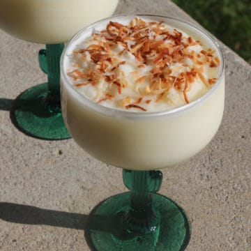 Toasted Coconut topped frozen cactus colada in a cactus margarita glass