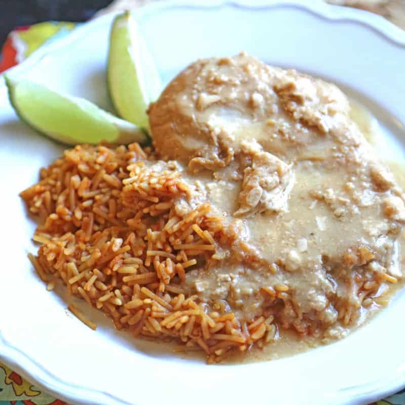 slow cooker tequila chicken next to rice and limes