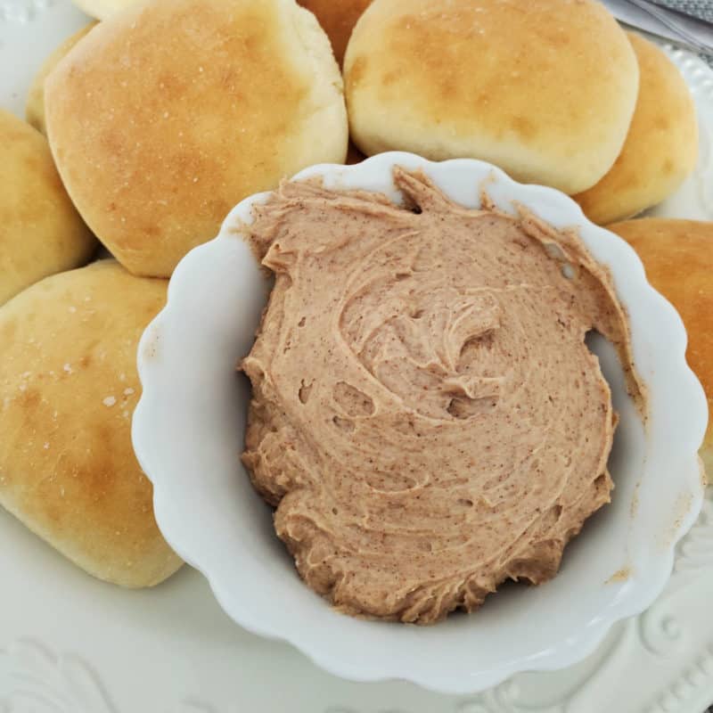 Texas Roadhouse Butter in a white bowl next to rolls