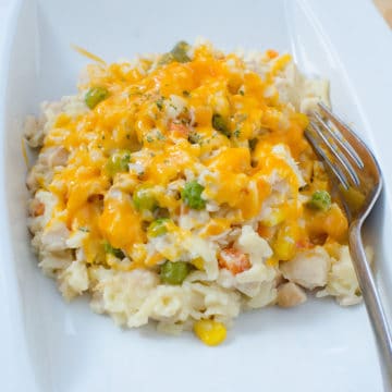 Chicken Orzo Casserole on a white plate with a fork