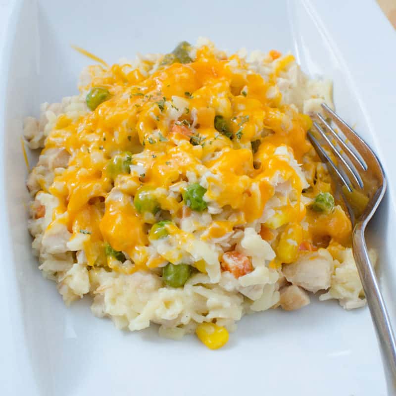 Chicken Orzo Casserole on a white plate with a fork